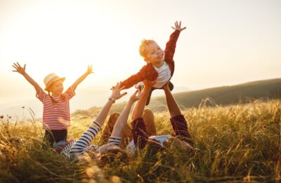 Happy family: mother, father, children son and  daughter on nature  on sunset